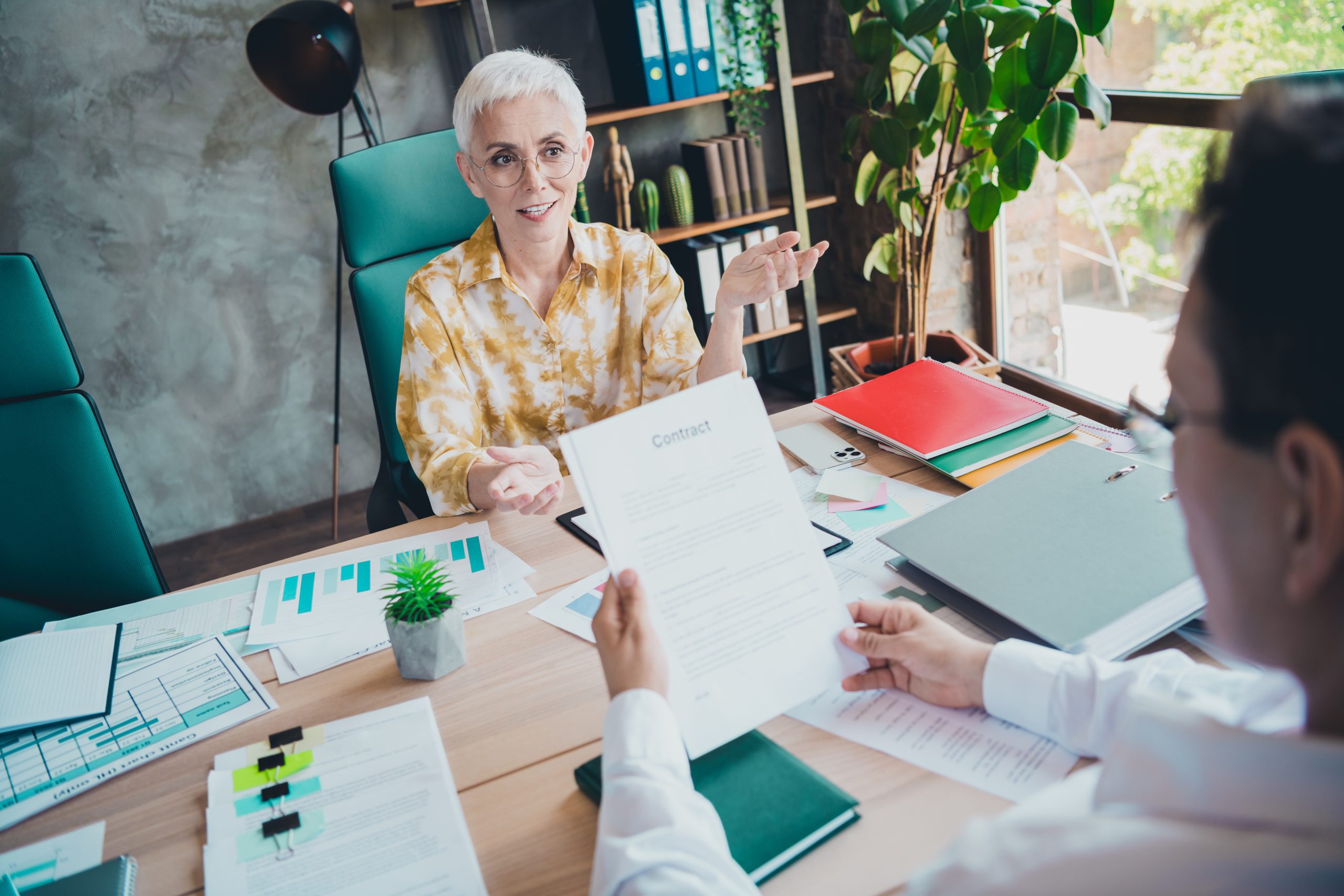 Photo of pretty retired female recruiter job interview man wear yellow print shirt formalwear coworking successful nice light office